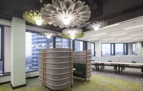 Modern designed office with original pendant lights, separated work areas and floor -to -ceiling windows with a city view.