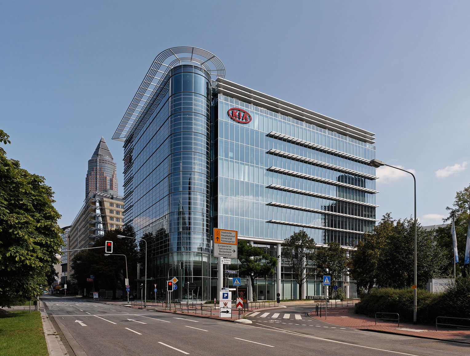 Side exterior view of KIA Motors building with glass frontage
