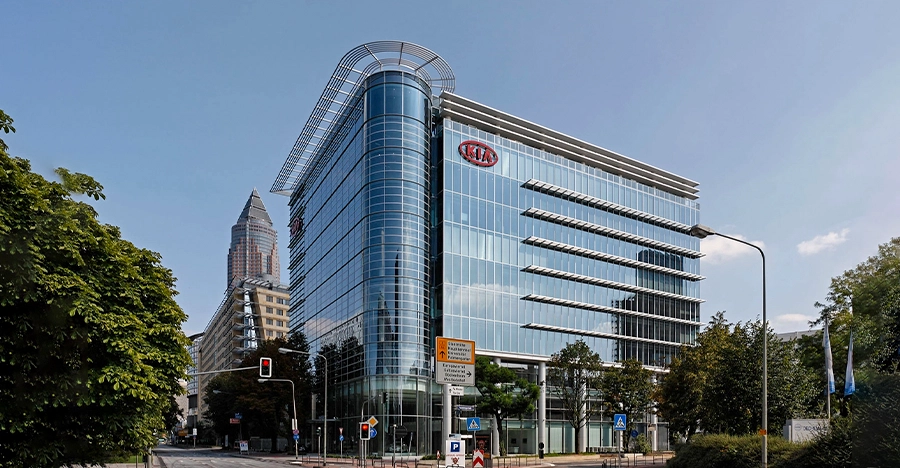 Side exterior view of KIA Motors building with glass frontage