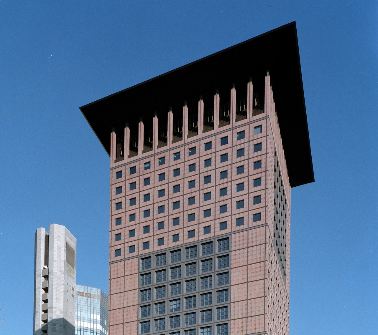 Japan Center in Frankfurt am Main with striking roof design and red façade against a blue sky.