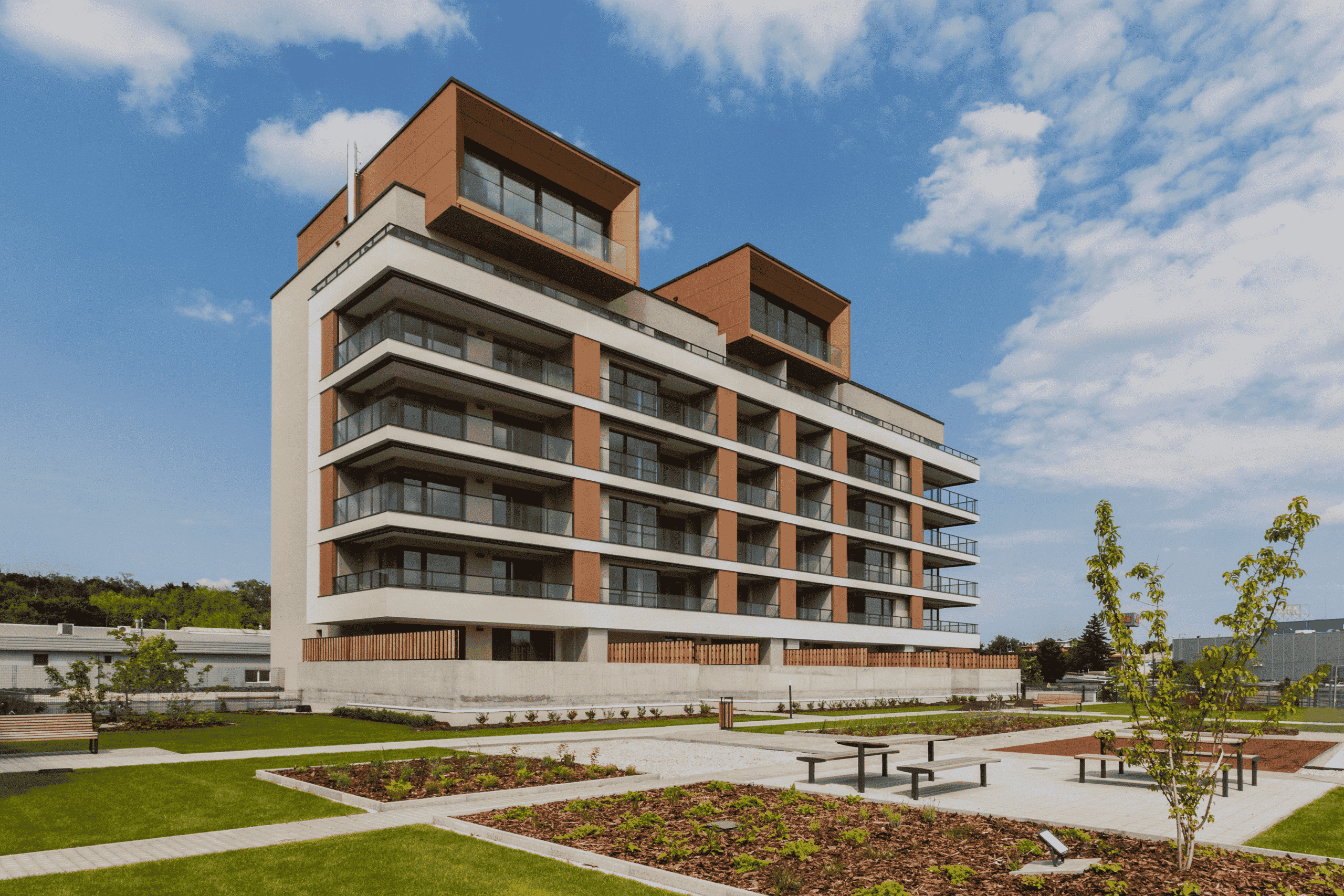 Modern multi-story building with sustainable design and technological innovations, surrounded by well-kept green spaces.