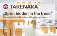 Exhibition with wooden models of traditional Japanese carpentry; text panel "Spirit hidden in the trees" in front, visitors in the background.