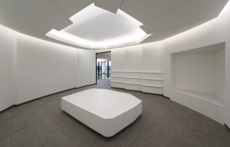 Modern office interior with a minimalist design and dynamic ceiling lighting, designed by Takenaka.