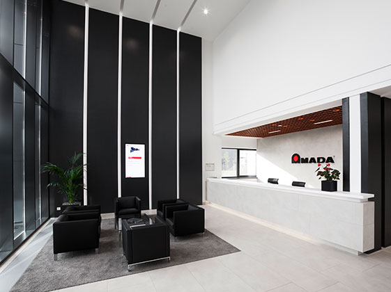 View of the information desk and waiting area at the Amada office in Germany, a design concept implemented by Takenaka.